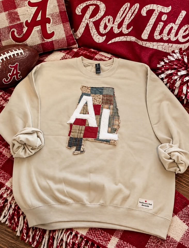 Cream sweatshirt with an Alabama-shaped vintage quilt appliqué hand-stitched with the letters AL