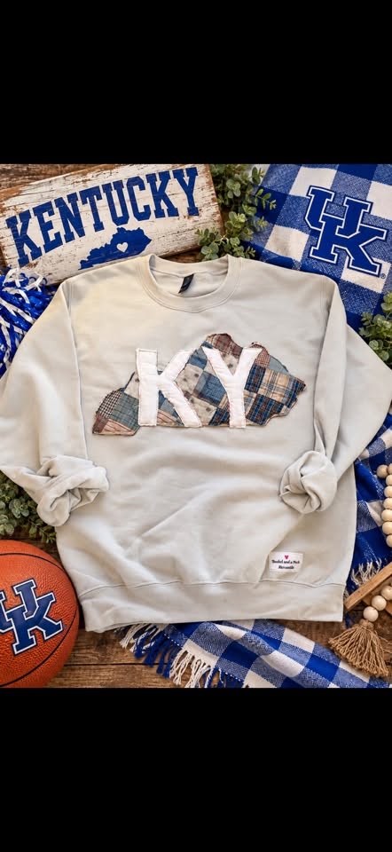 Heather gray sweatshirt with the letters KY inside a Kentucky-shaped patch of blue, tan, and cream plaid quilt scraps