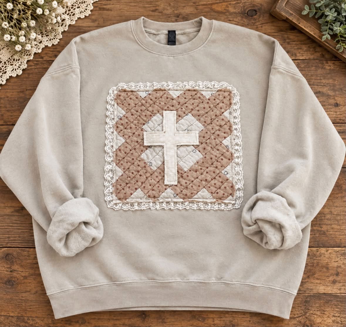 Sand sweatshirt with a square vintage quilt patch in brown dot and cream prints, edged in white eyelet lace and appliquéd with an off-white cross
